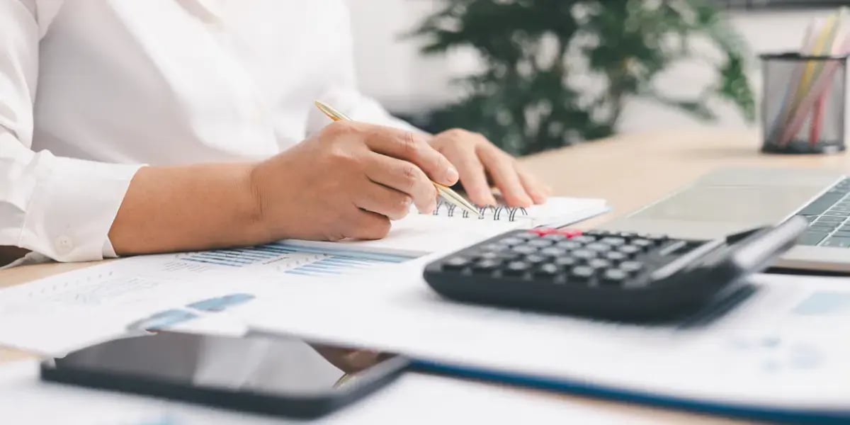accountant working on tax planning at a desk with their supplies