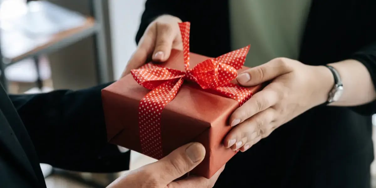 employee receiving company gift in red wrapping