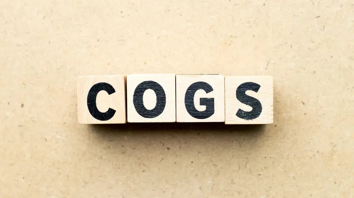 blocks that spell COGS on a tabletop