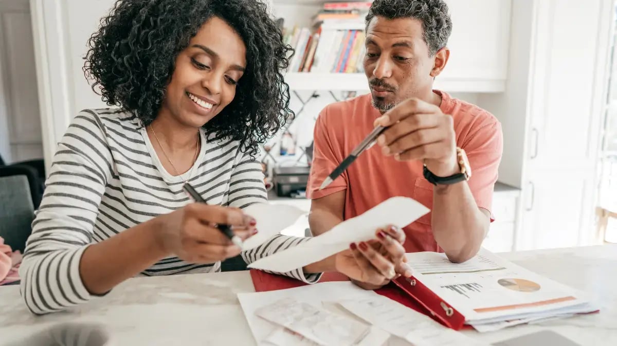 Couple sitting at table working on their tax information