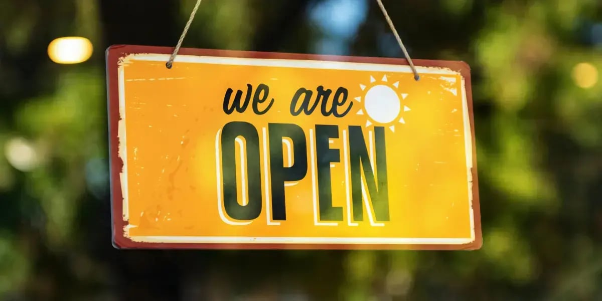 orange sign on a glass door that reads 