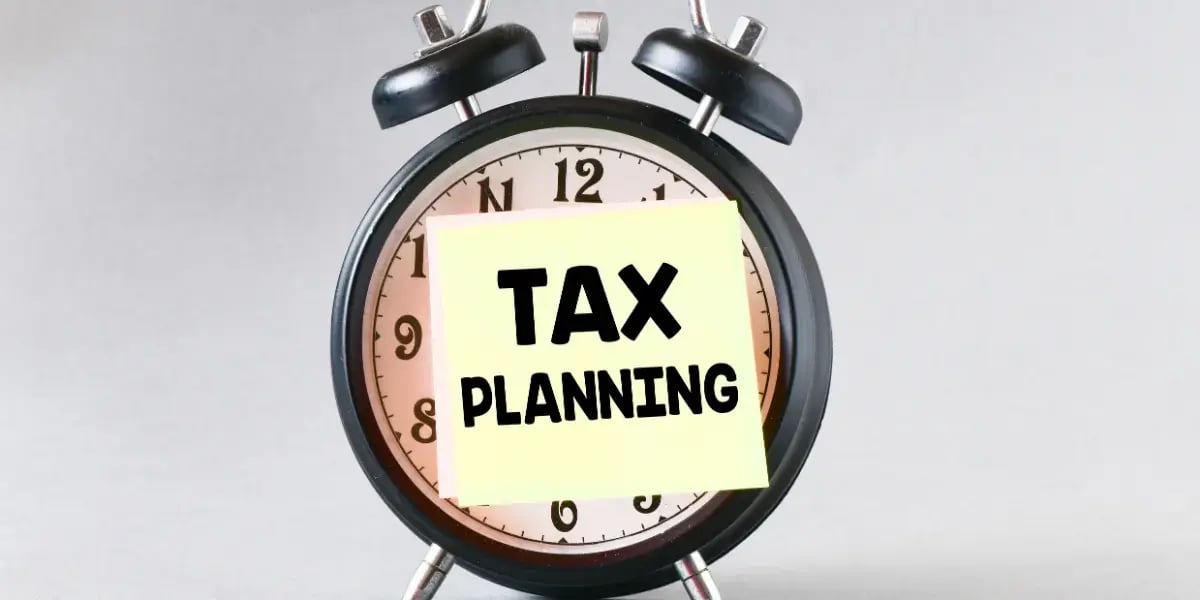 alarm clock with a sticky note over it that states 