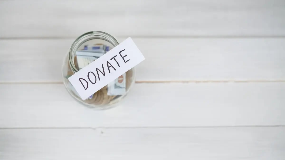 Donation jar on a wooden table top