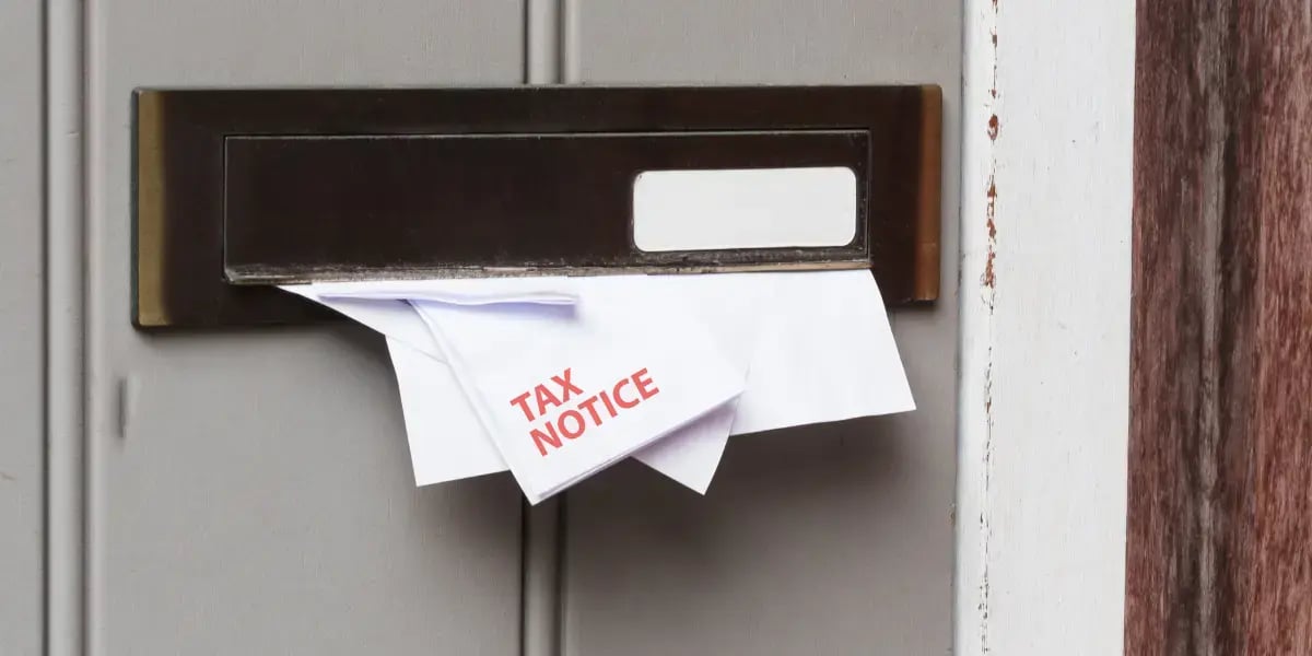 Tax Notice papers sticking out of a mailbox
