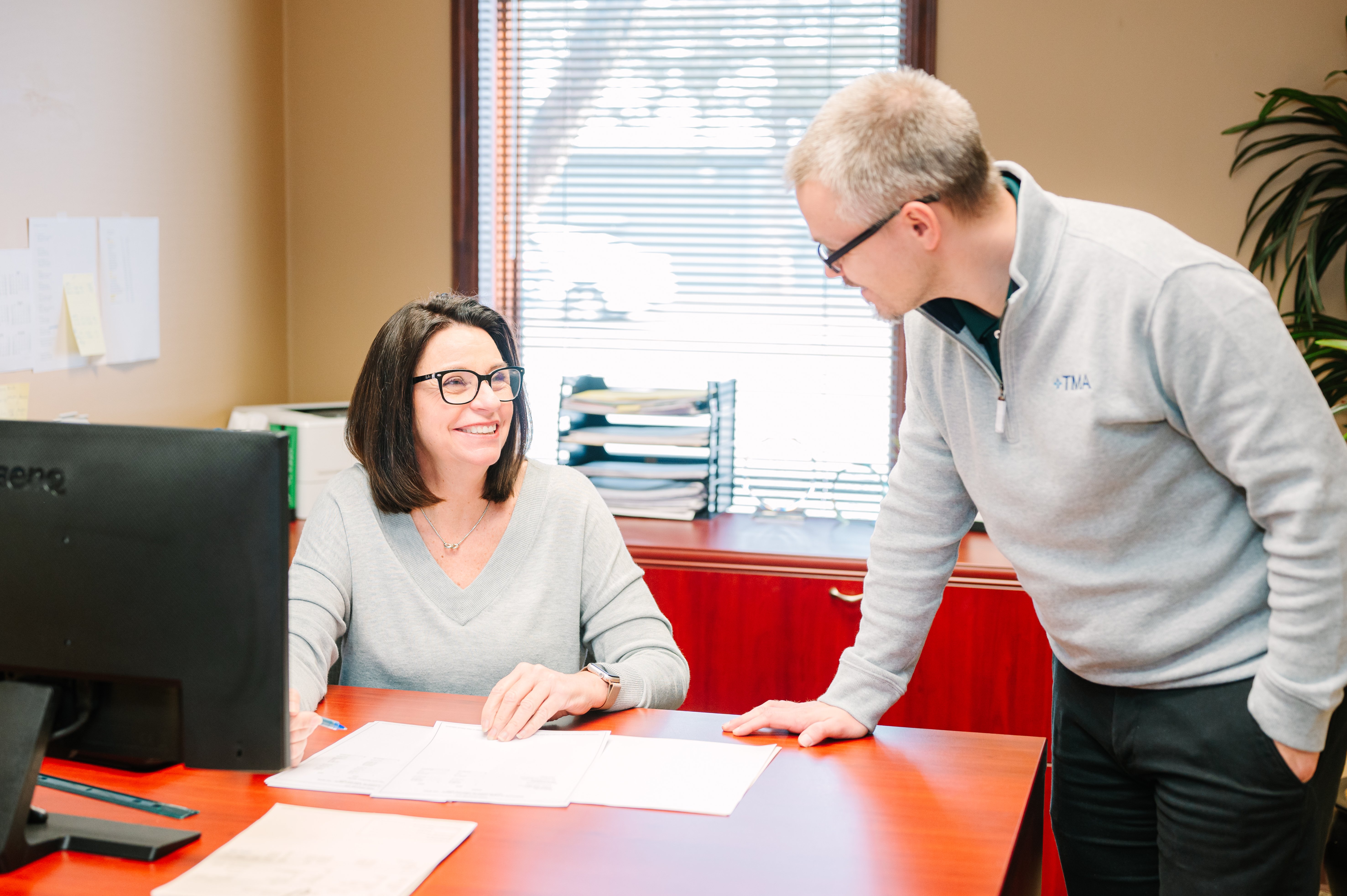 TMA employees working together in office